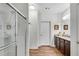 Modern bathroom features a glass-enclosed shower, granite countertops, and plenty of cabinet space at 4410 Chaney Ct, Cumming, GA 30028