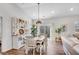 Bright dining room with stylish decor, modern lighting, and a sliding glass door for natural light at 4410 Chaney Ct, Cumming, GA 30028