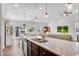 Open concept kitchen features granite countertops, modern pendant lighting, and stainless steel appliances at 4410 Chaney Ct, Cumming, GA 30028