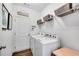 Laundry area equipped with a washer, dryer, and overhead storage at 4410 Chaney Ct, Cumming, GA 30028