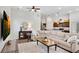 Open floor plan with kitchen view, featuring hardwood floors and a large sectional sofa at 4410 Chaney Ct, Cumming, GA 30028