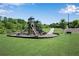 Community playground area with slides and climbing structures, surrounded by lush greenery at 4410 Chaney Ct, Cumming, GA 30028