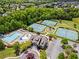 Aerial view of community amenities featuring a pool, tennis courts, and clubhouse at 6170 Weddington Dr, Cumming, GA 30040