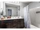 Bathroom featuring a sink, mirror, and tub with blue floral shower curtain at 6170 Weddington Dr, Cumming, GA 30040