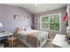 Charming bedroom with a window, decorated with pink bedding and shelves at 6170 Weddington Dr, Cumming, GA 30040