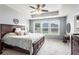 Bright bedroom with tray ceiling, plush bedding, large windows, and elegant furnishings at 6170 Weddington Dr, Cumming, GA 30040