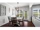 Bright dining area with modern chandelier, hardwood floors, and views of the backyard at 6170 Weddington Dr, Cumming, GA 30040