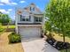 Charming two-story home with brick accents, a two-car garage, and a well-maintained lawn and manicured garden at 6170 Weddington Dr, Cumming, GA 30040