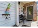 Inviting front porch with stylish decor, a bench, and a welcoming entrance with lemons at 6170 Weddington Dr, Cumming, GA 30040