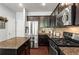 Spacious kitchen with stainless steel appliances, granite countertops, dark wood cabinetry, and tiled backsplash at 6170 Weddington Dr, Cumming, GA 30040