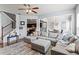 Inviting living room with soft sectional sofa, open layout, wood floors, and view to kitchen and dining areas at 6170 Weddington Dr, Cumming, GA 30040