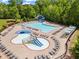 Aerial view of the neighborhood pool and play area surrounded by trees at 6170 Weddington Dr, Cumming, GA 30040