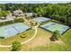 Aerial view of community amenities featuring tennis courts, pool, clubhouse, and playground at 6170 Weddington Dr, Cumming, GA 30040