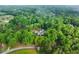Aerial view captures a secluded home with a private pool nestled among a dense forest at 65 Maude White Rd, Kingston, GA 30145
