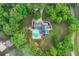 Aerial view shows lush landscaping, winding drive, and in-ground pool of stunning residential home at 65 Maude White Rd, Kingston, GA 30145