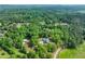 Expansive aerial view shows a home with a pool nestled within a lush, green and dense forest at 65 Maude White Rd, Kingston, GA 30145
