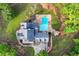 Aerial view of a private home with a uniquely shaped pool nestled within a lush green landscape at 65 Maude White Rd, Kingston, GA 30145