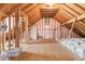 Unfinished attic with exposed beams, insulation and a boarded floor at 65 Maude White Rd, Kingston, GA 30145
