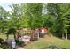 Outdoor patio featuring a pergola, dining set, and lush landscaping, perfect for entertaining at 65 Maude White Rd, Kingston, GA 30145