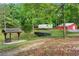 Scenic backyard with a gazebo, bridge, storage building and a red barn at 65 Maude White Rd, Kingston, GA 30145