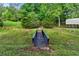 Wooden bridge, storage building and storage shed spanning a creek in a lush backyard setting at 65 Maude White Rd, Kingston, GA 30145