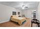 Cozy bedroom featuring a floral bedspread, ceiling fan, and closet access at 65 Maude White Rd, Kingston, GA 30145