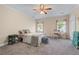 Comfortable bedroom features neutral carpet, ceiling fan, and plenty of natural light at 65 Maude White Rd, Kingston, GA 30145