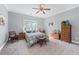 Inviting bedroom features neutral carpet, ceiling fan, and a sunny window at 65 Maude White Rd, Kingston, GA 30145