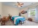 Cozy bedroom featuring a comfortable bed, ceiling fan, and a bright window at 65 Maude White Rd, Kingston, GA 30145