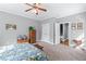 Comfortable bedroom features neutral carpet, ceiling fan, and ensuite access at 65 Maude White Rd, Kingston, GA 30145