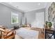 Cozy bedroom features hardwood floors, a large area rug, and a sunny window at 65 Maude White Rd, Kingston, GA 30145