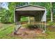 Long covered carport on a green lawn surrounded by trees at 65 Maude White Rd, Kingston, GA 30145