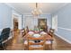 A dining room is showcased with a chandelier, hardwood flooring and a view into the living room at 65 Maude White Rd, Kingston, GA 30145