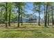 Beautiful home exterior surrounded by lush greenery and mature trees at 65 Maude White Rd, Kingston, GA 30145
