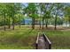 Charming blue house with a small bridge in the yard, surrounded by trees at 65 Maude White Rd, Kingston, GA 30145
