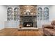 Beautiful stone fireplace with built-in shelving showcasing decorative accents and cozy ambiance at 65 Maude White Rd, Kingston, GA 30145