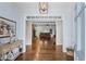 Bright foyer with hardwood floors, elegant lighting, and an open view to the living room with a fireplace at 65 Maude White Rd, Kingston, GA 30145