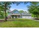 Inviting two-story home with three-car garage, stone accents, covered porch and professionally landscaped front yard at 65 Maude White Rd, Kingston, GA 30145
