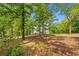 Spacious front yard with mature trees surrounding a charming two-story home at 65 Maude White Rd, Kingston, GA 30145