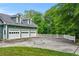 Three-car garage with large driveway and white picket fence offering ample parking at 65 Maude White Rd, Kingston, GA 30145