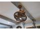 A unique caged ceiling fan is featured in this kitchen with exposed beams at 65 Maude White Rd, Kingston, GA 30145