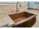 A close up view of the copper farmhouse sink and granite countertops at 65 Maude White Rd, Kingston, GA 30145