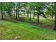 Scenic view of sloping lawn surrounded by a split rail fence and mature shade trees at 65 Maude White Rd, Kingston, GA 30145