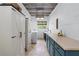 A stylish laundry room featuring custom cabinetry, shiplap walls, and modern appliances at 65 Maude White Rd, Kingston, GA 30145