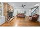 Cozy living room features a stone fireplace, hardwood floors, and comfortable leather furniture at 65 Maude White Rd, Kingston, GA 30145