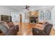 Open-concept living room with a stone fireplace, built-in shelving, and ample seating at 65 Maude White Rd, Kingston, GA 30145