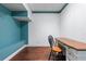 Home office with wooden desk, chair, and blue accent wall at 65 Maude White Rd, Kingston, GA 30145