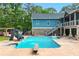 Inviting backyard pool with slide, diving board, water features, and nearby outdoor dining area at 65 Maude White Rd, Kingston, GA 30145