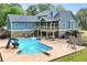 Outdoor swimming pool with slide and diving board, surrounded by a patio and landscaped yard at 65 Maude White Rd, Kingston, GA 30145