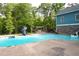 Scenic backyard with sparkling pool, slide, water features, pergola and lush greenery at 65 Maude White Rd, Kingston, GA 30145
